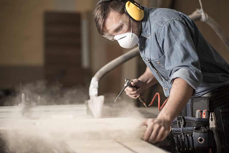 A carpenter sanding wood