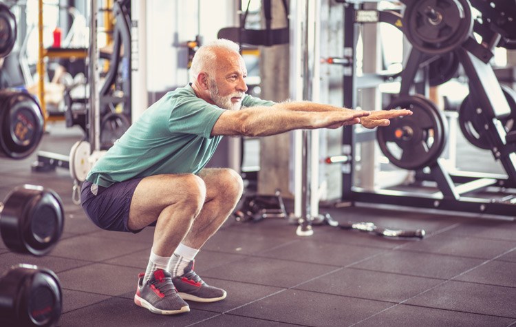 Senior man exercising at a  gym.