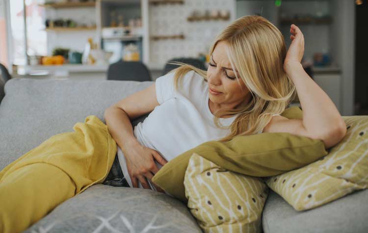 Woman with hands on stomach