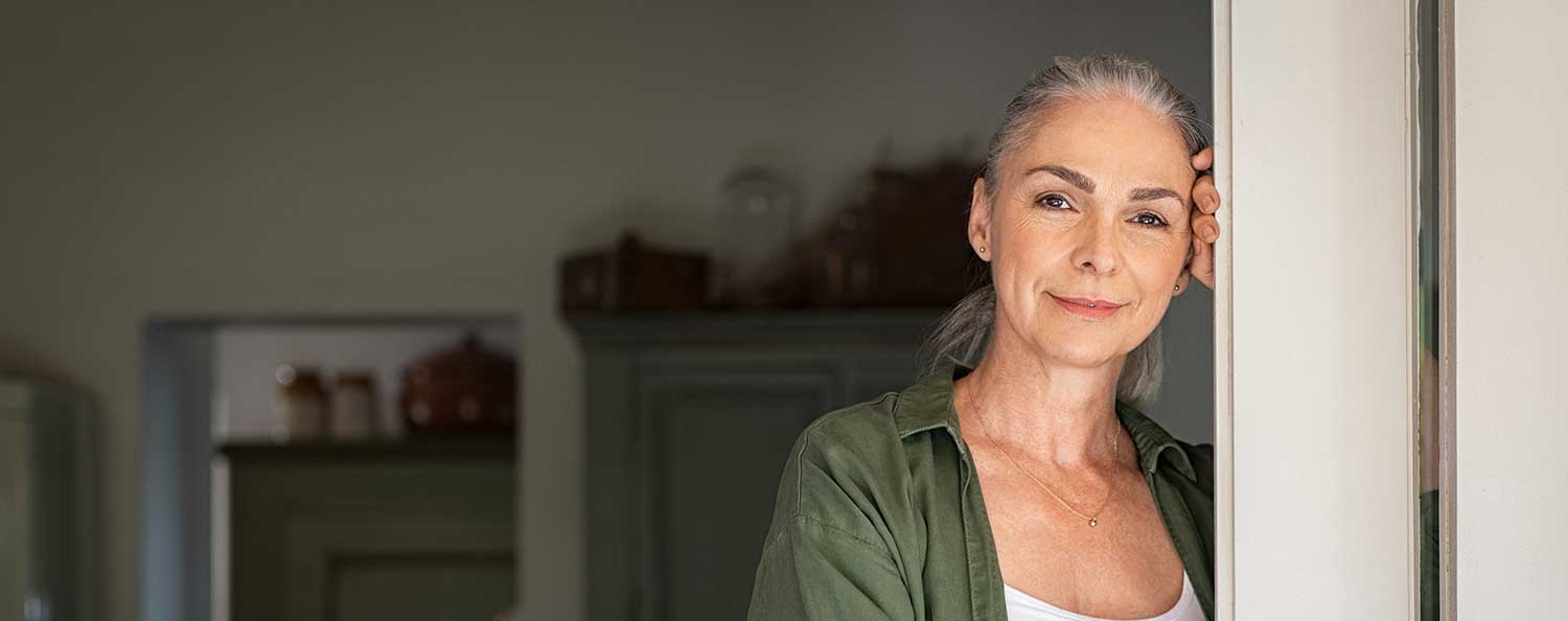 Older lady standing in a doorway