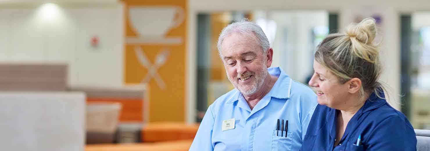 Two people chatting in the Atrium