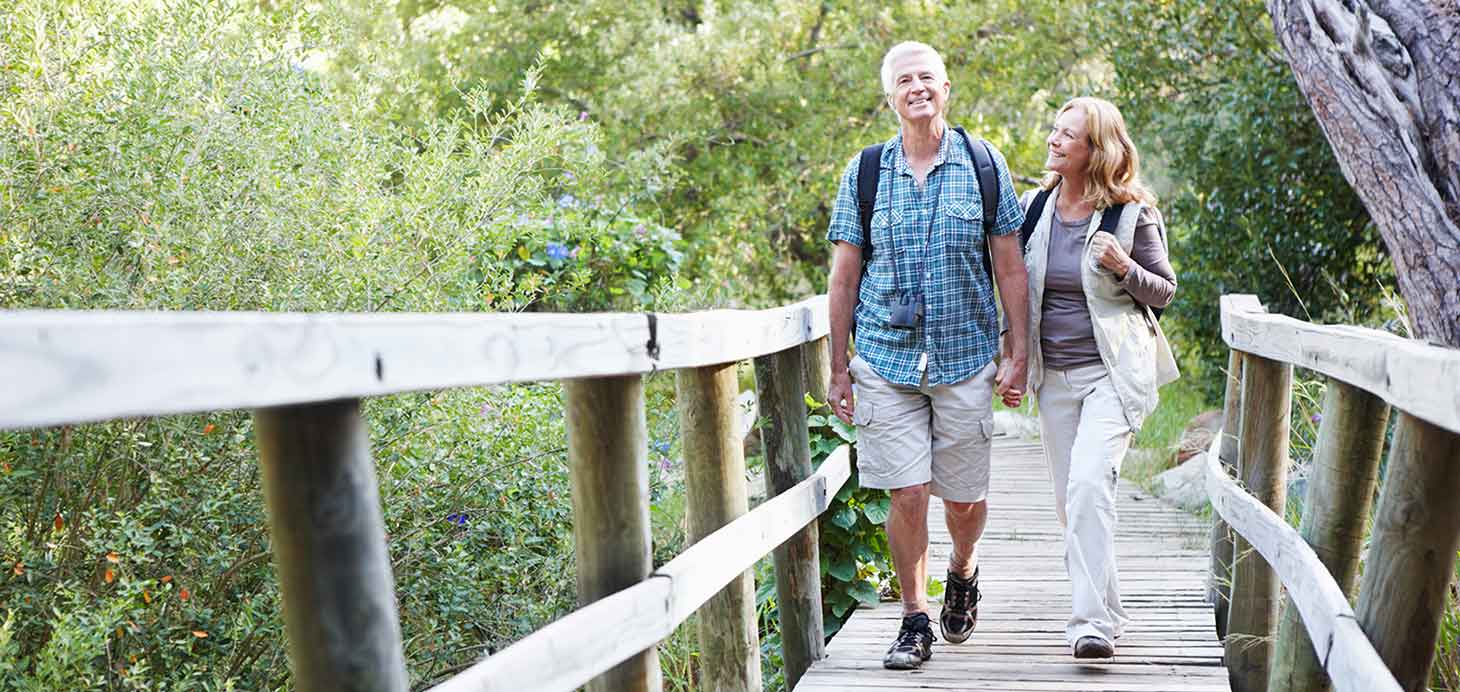Middle aged couple walking on bridge