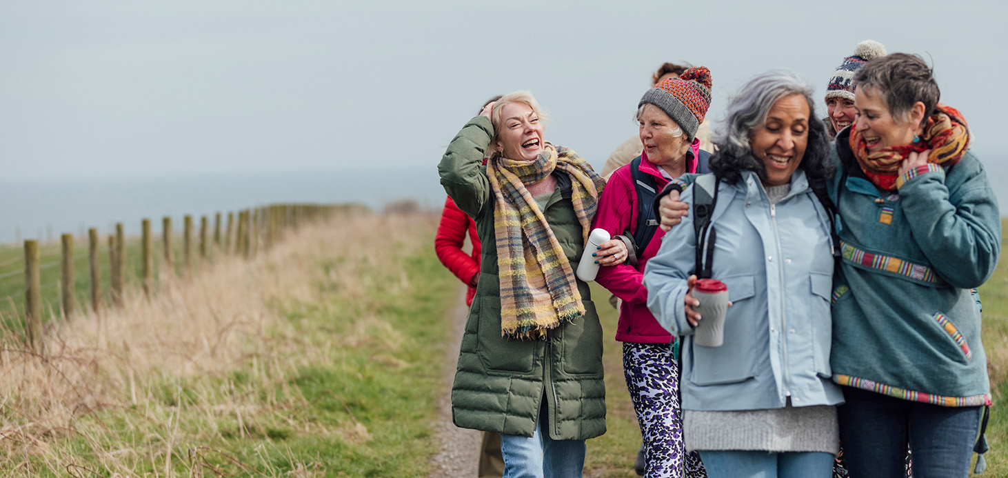 Middle aged couple walking on bridge
