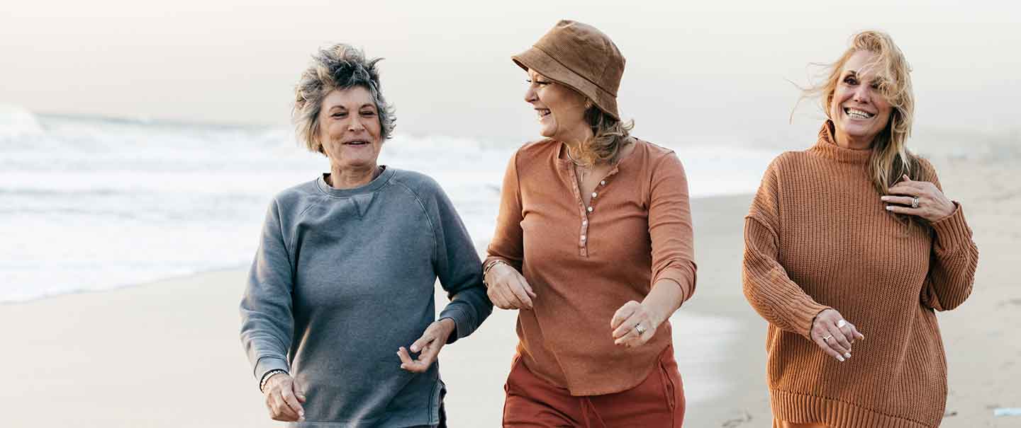 Three women walking on a beach
