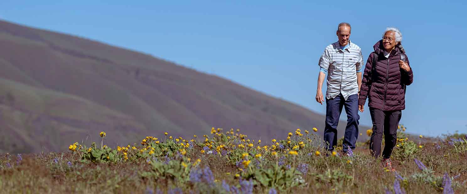 Older couple walking in the hills
