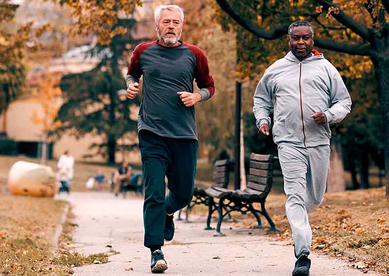 Two middle aged men running