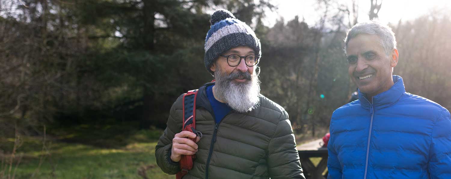 Two men walking in the winter sunshine