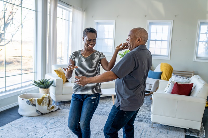 A couple dancing in their front room