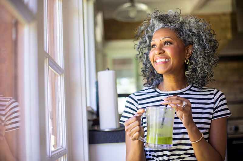 Woman drinking a green smoothie