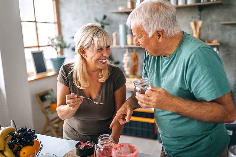 Couple laughing in the kitchen