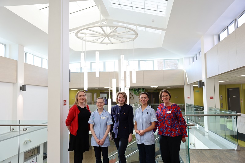 Katie Lam standing with hospital staff in the main atrium