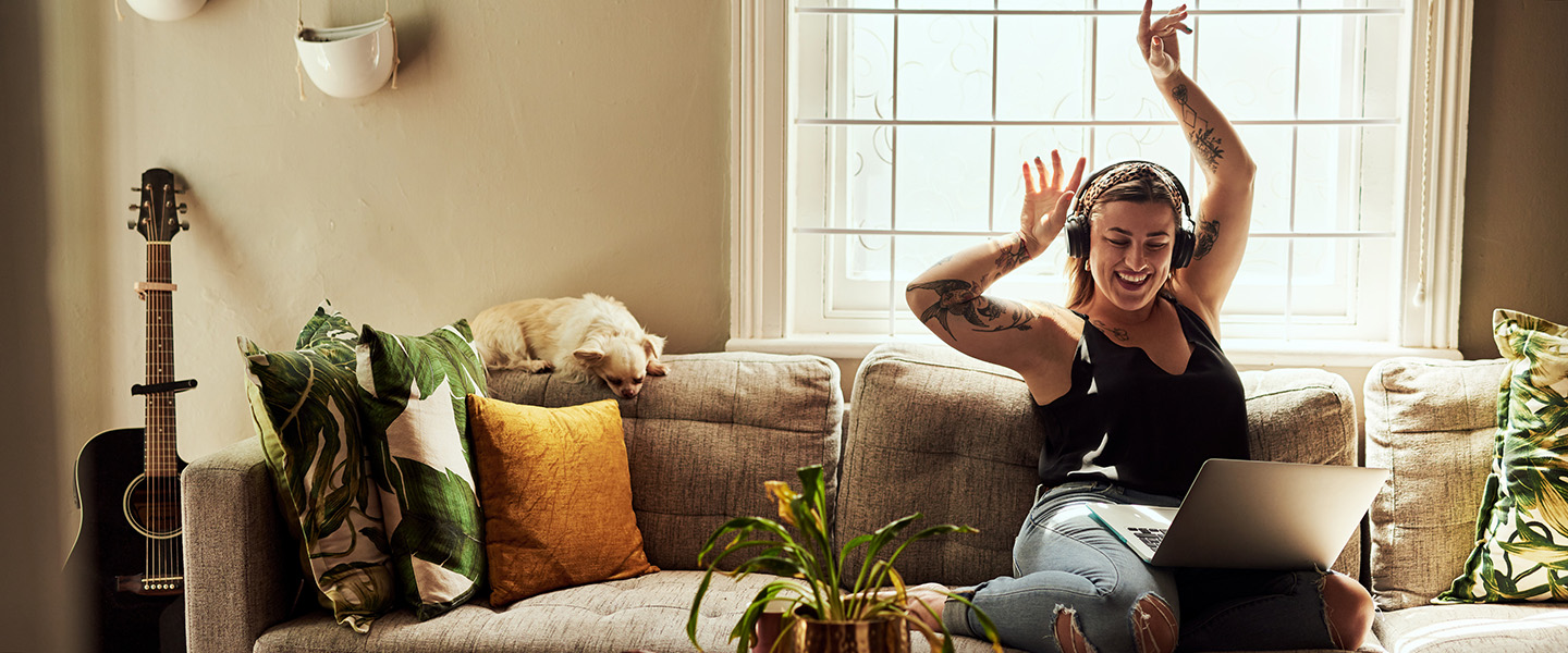 Woman listening to music on her sofa