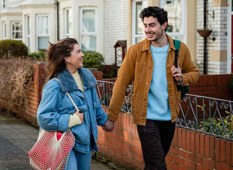 A young couple walking down the street