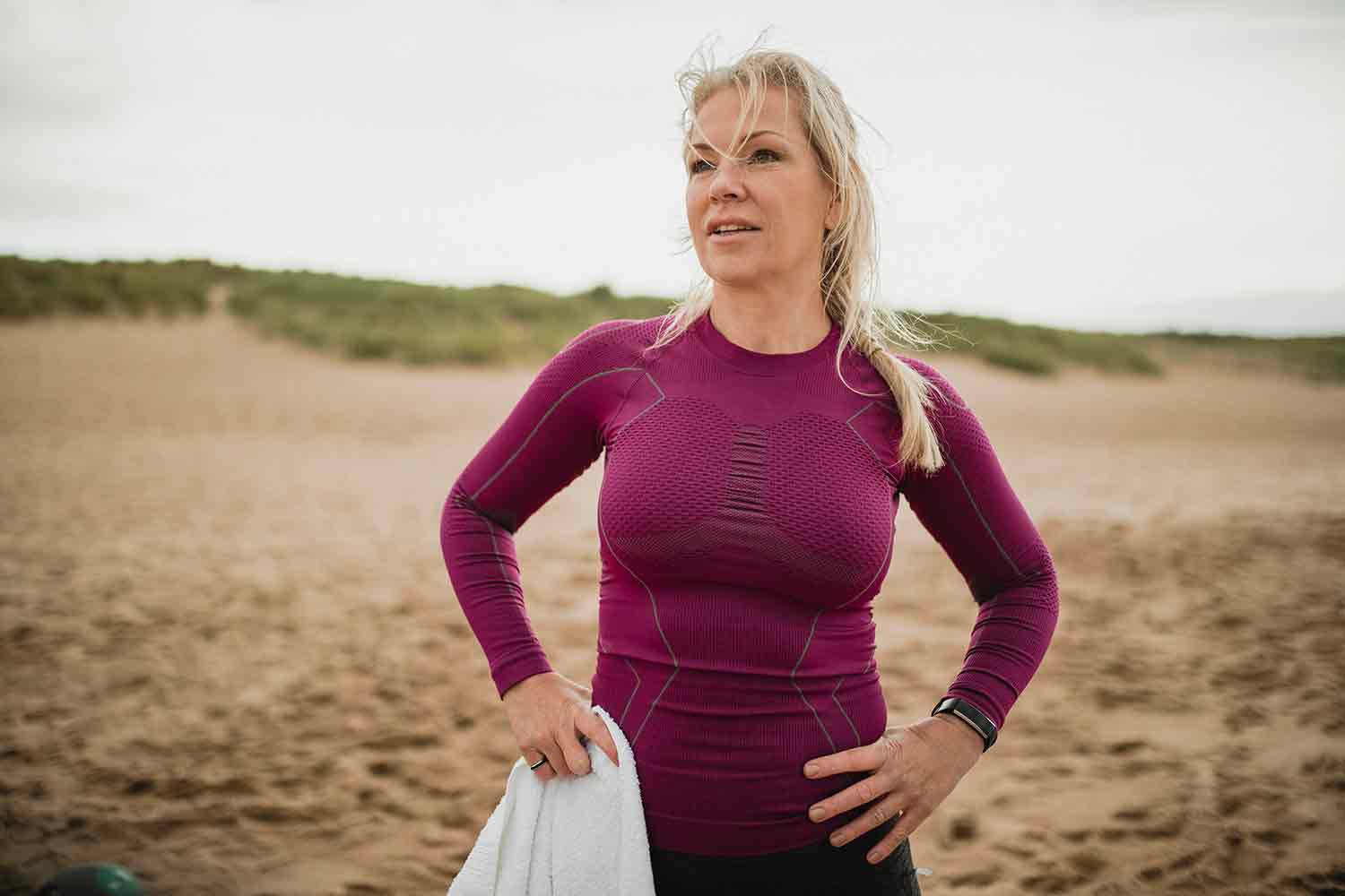 A woman standing still after a run in the countryside