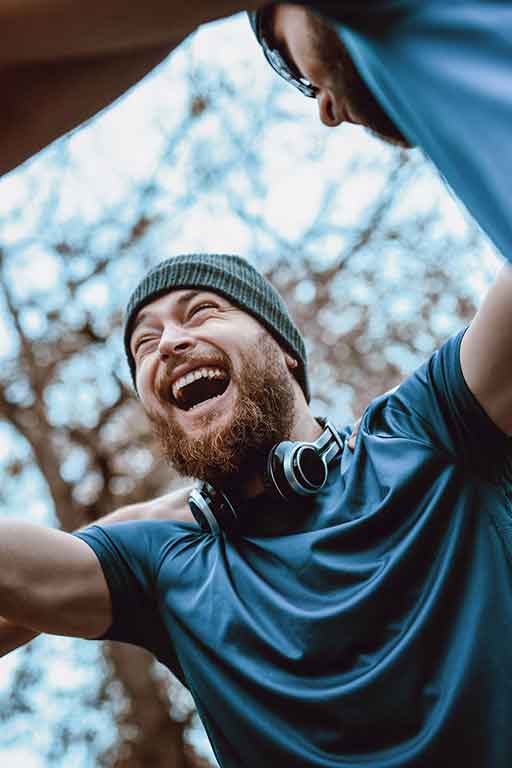 A man laughing with his friends