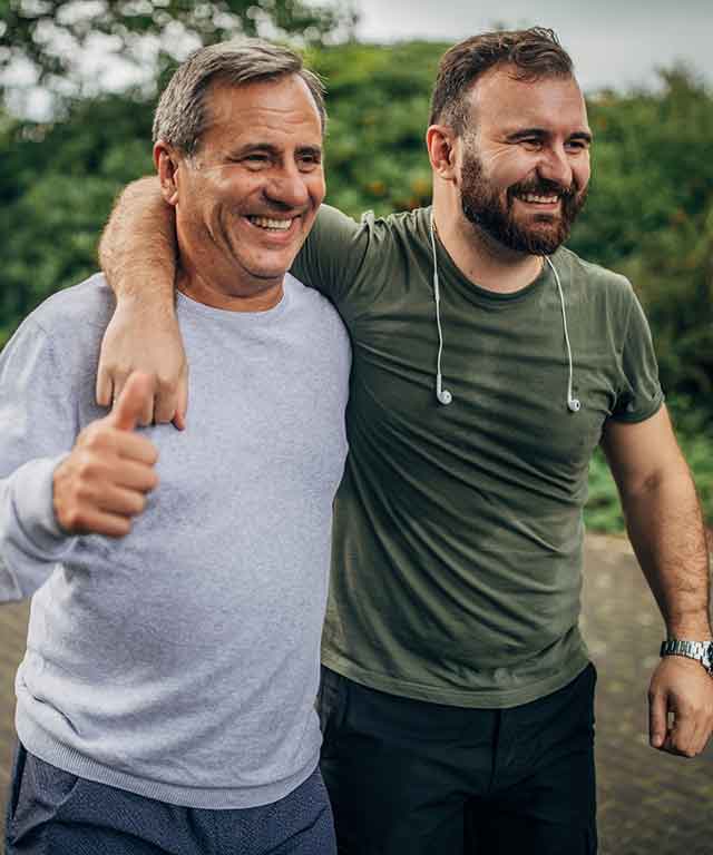 A woman in a jumper smiling at camera