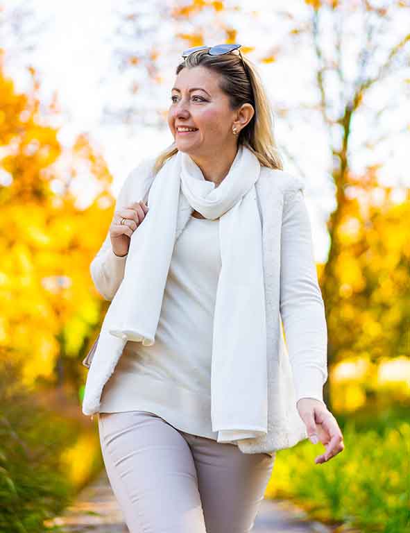 A woman in a jumper smiling at camera