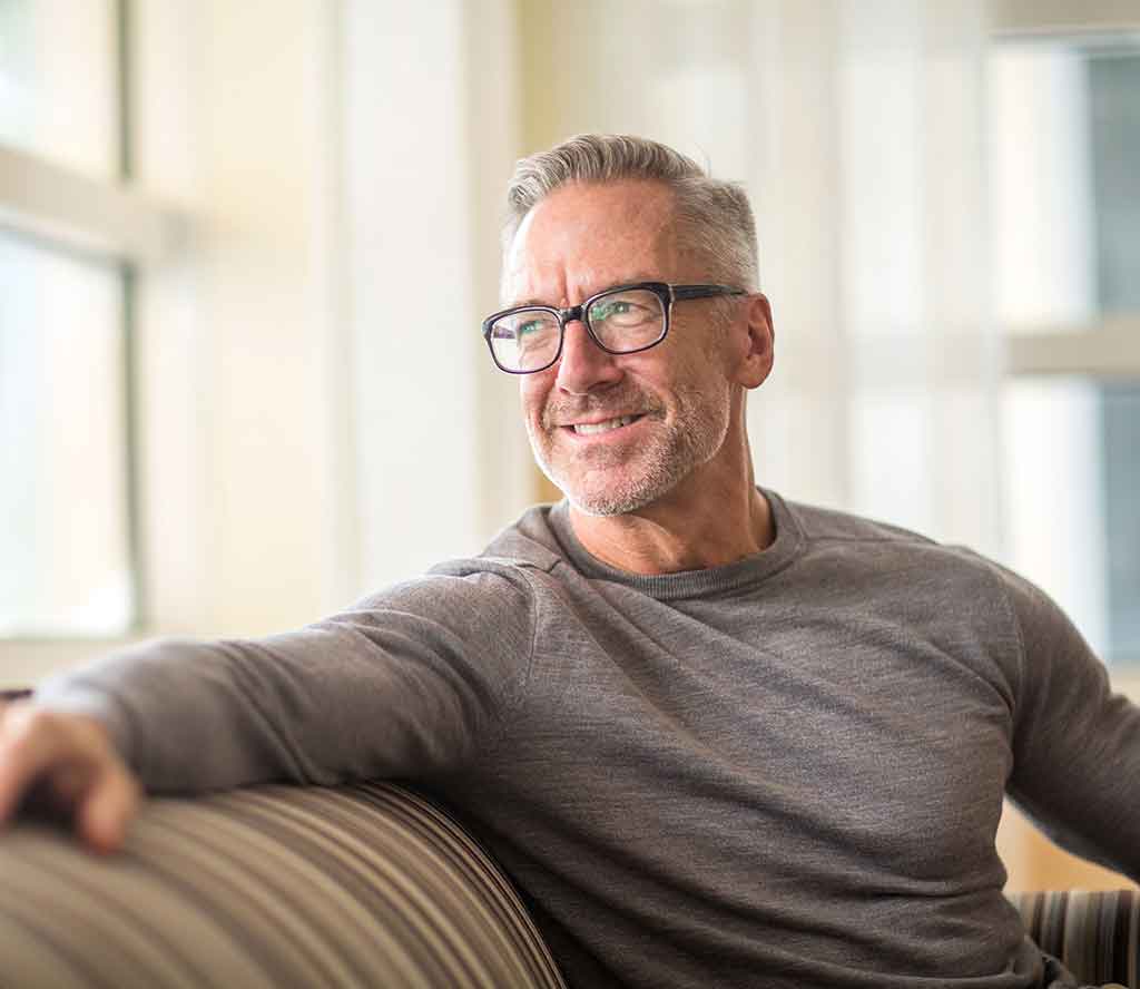 A man sitting on the sofa looking out of the window