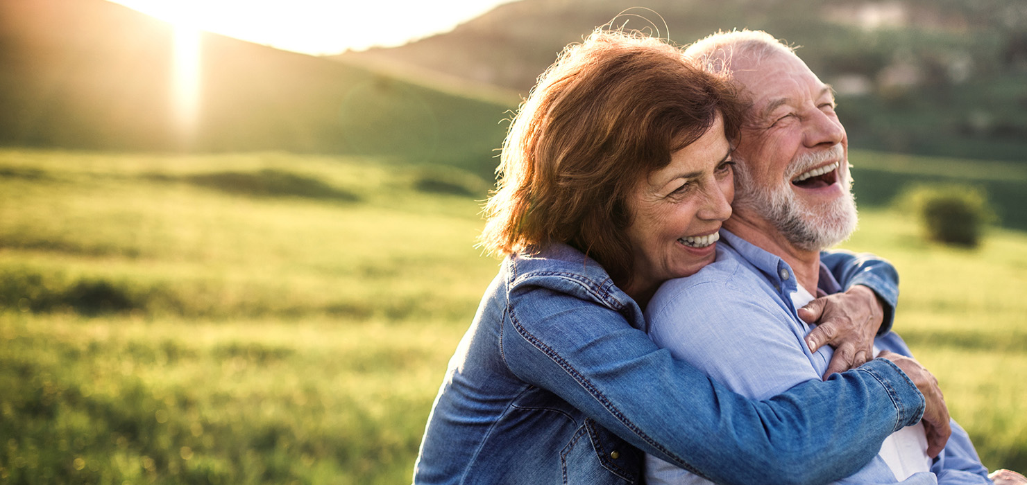 Senior couple hugging and smiling