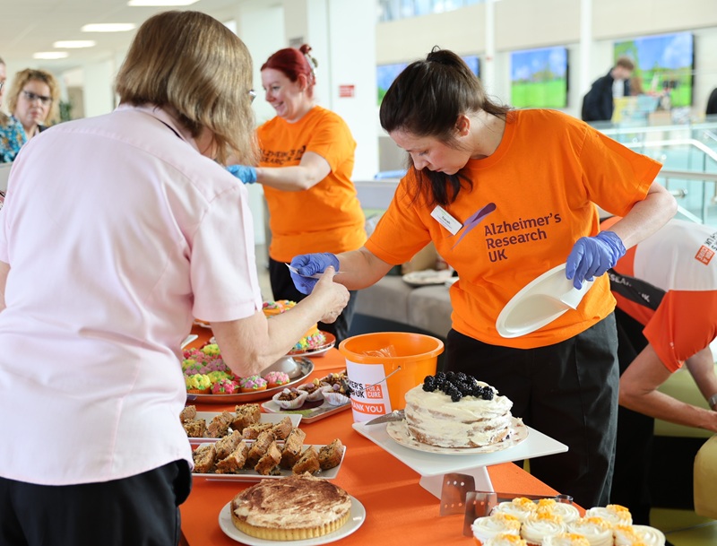 A busy charity fair bake sale stand