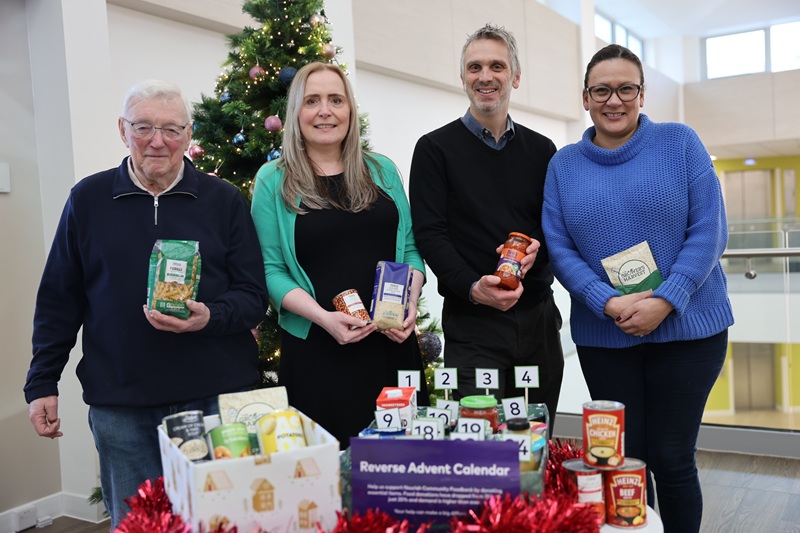 A group with a food bank donation box
