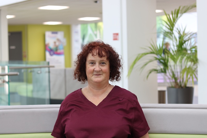 A member of clinical staff in a hospital atrium 