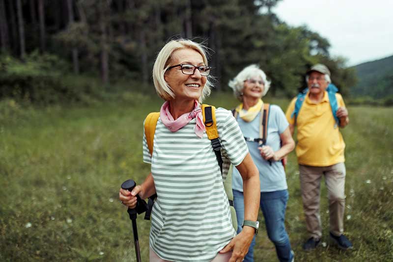 A group of older people walking in the countryside
