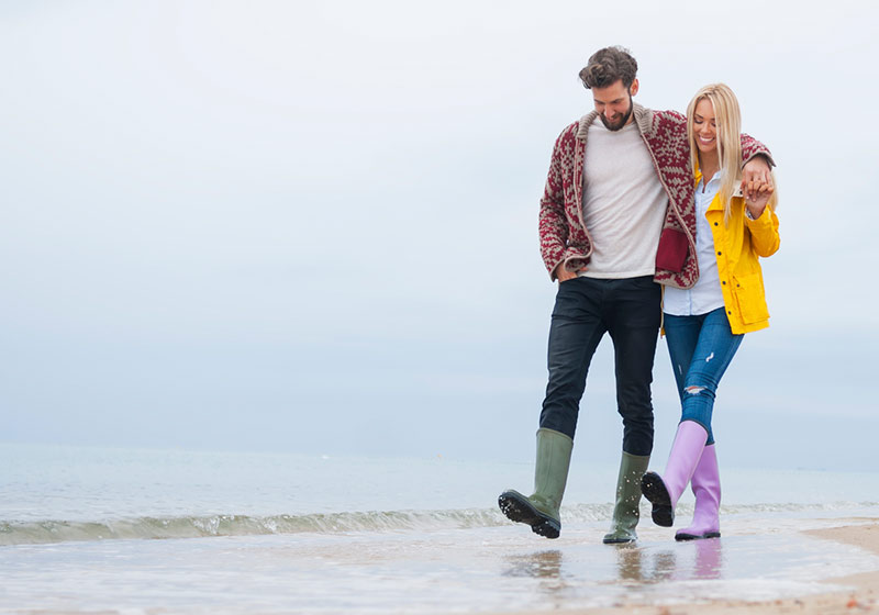 A couple walking along the beach