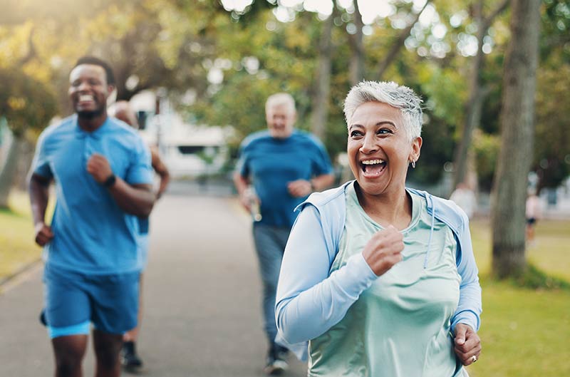 A group of people running in the park