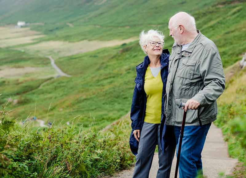 A woman and man walking in the hills