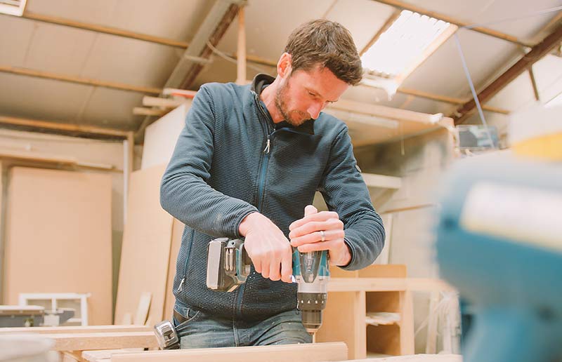 A man using a power sander