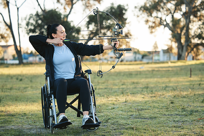 Lady in a wheelchair doing archery