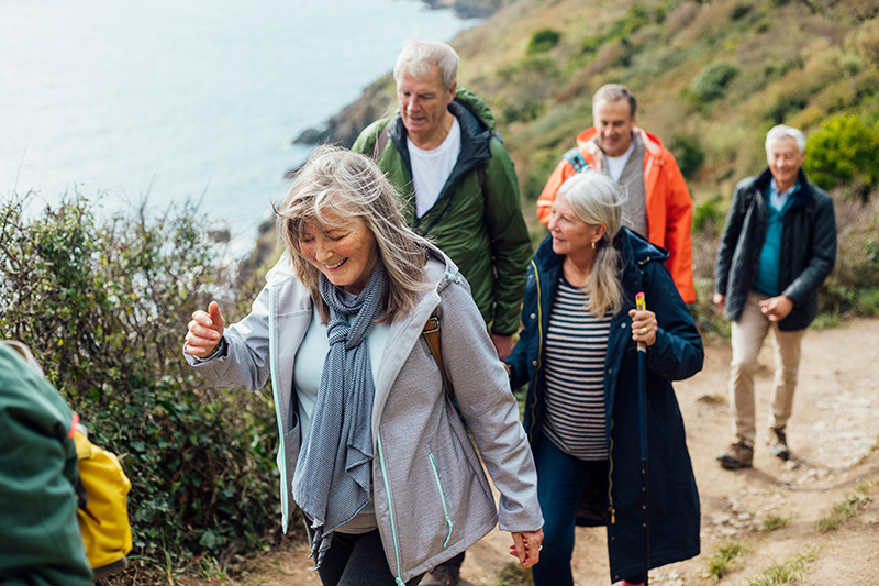 A group of people walking up a hill