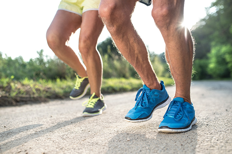 Focus on the legs of two people running