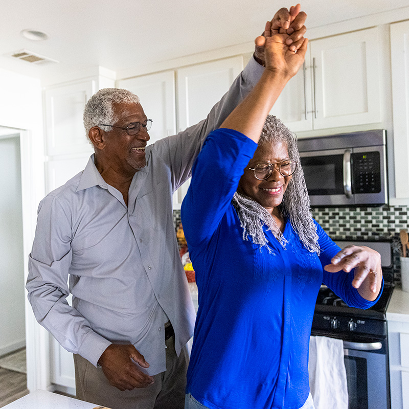 Senior couple dancing in the kitchen