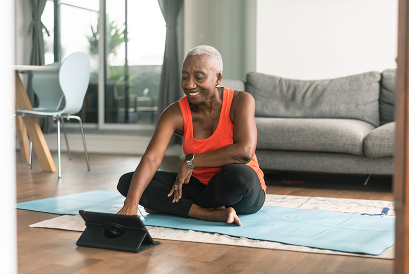 Senior woman sitting on a yoga mat