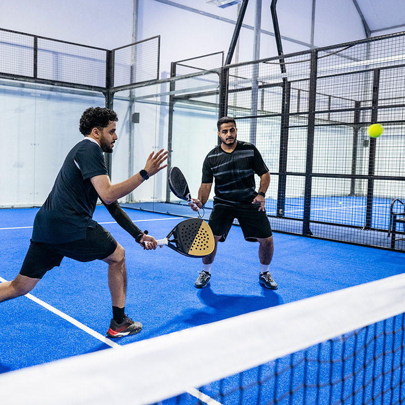 Two men playing padel