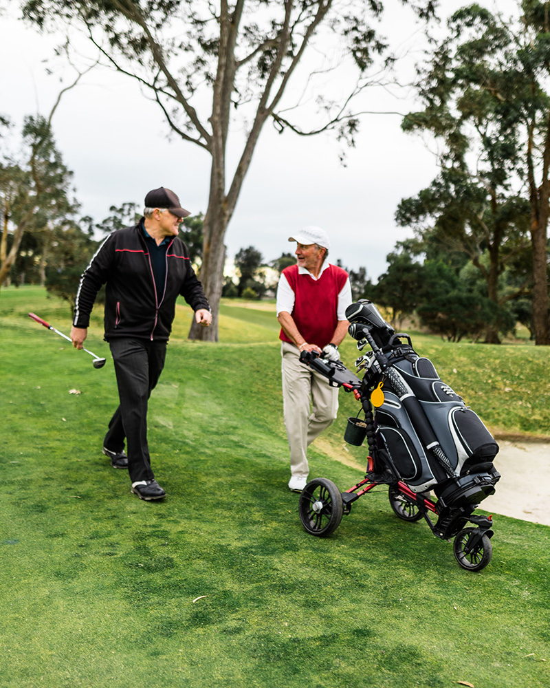 Two senior men playing golf