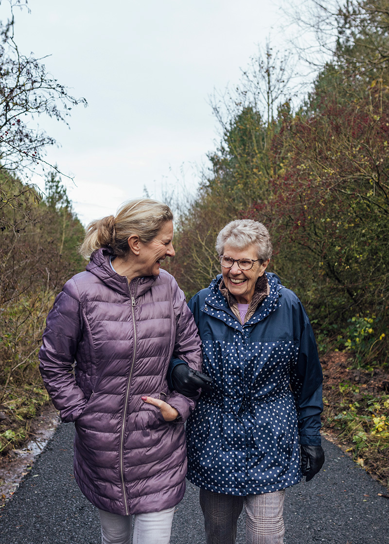 Mature mother and daughter walking