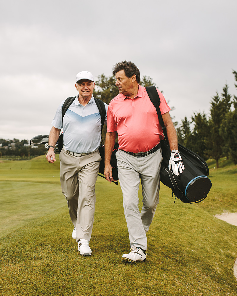 Two senior men playing golf