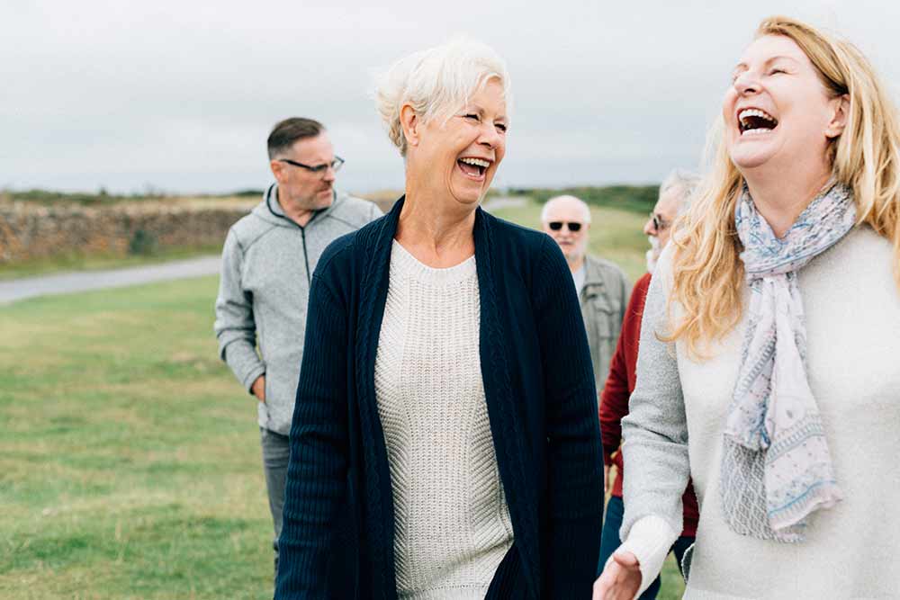 A group of people walking and laughing