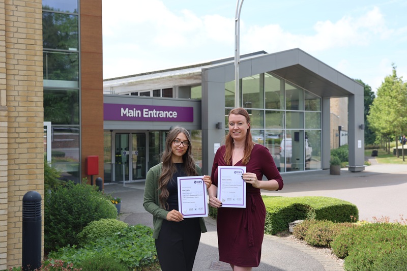 Two Procurement team members holding their MCIPS certificates