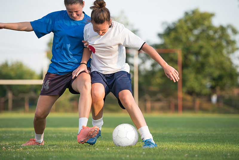 Two women playing football