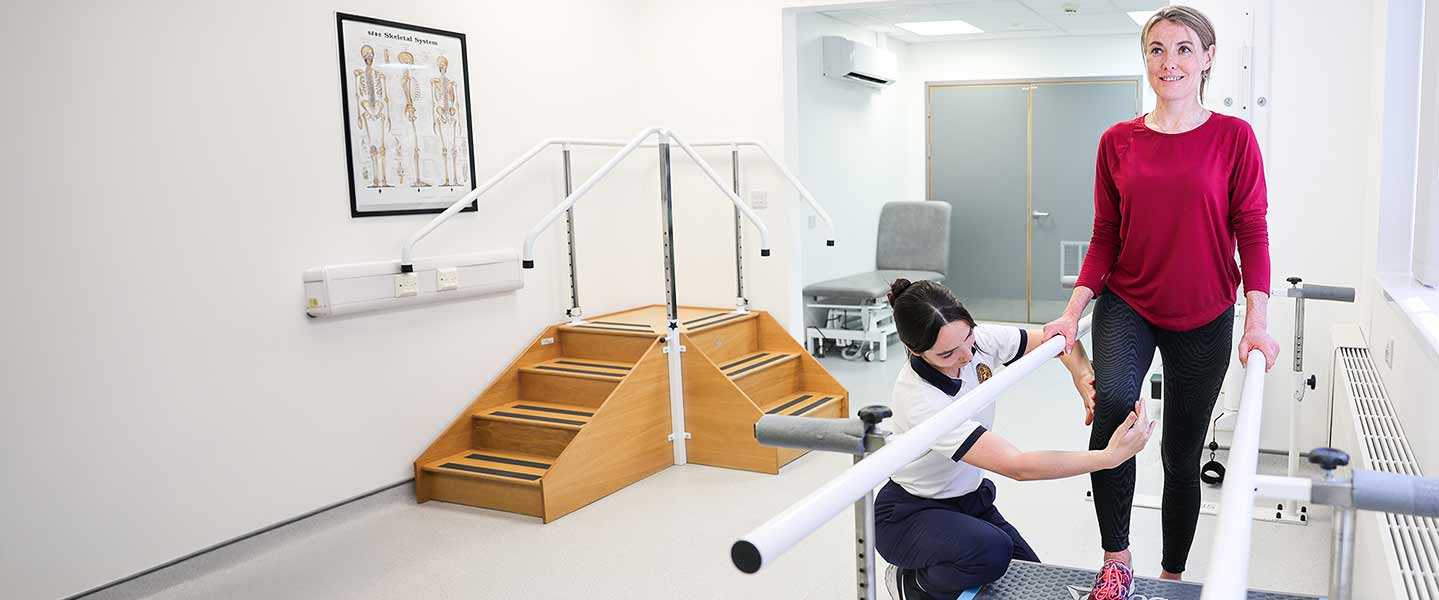 A physiotherapist assessing a patient's mobility