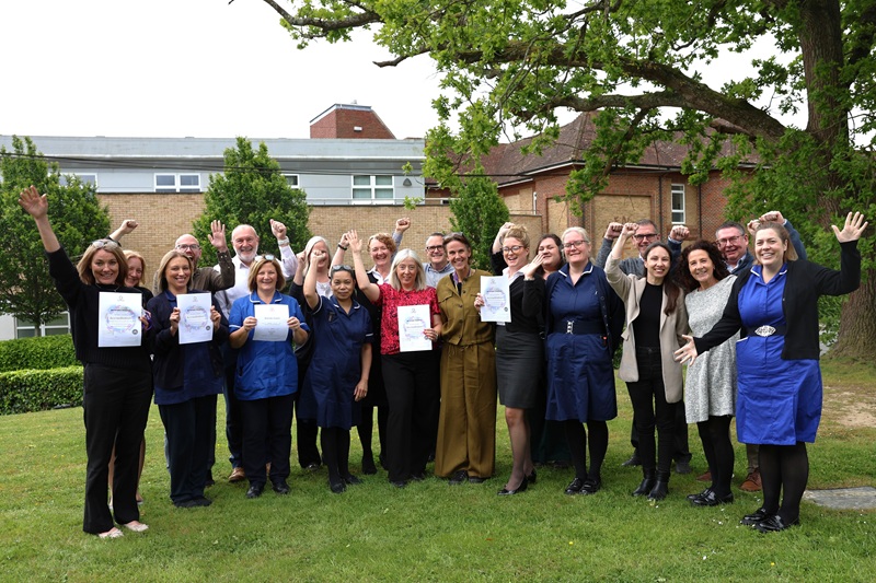 A group of hospital staff celebrating with CHKS accreditation certificates 