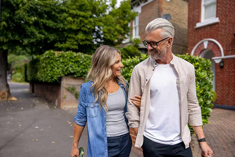 A man and woman walking and talking
