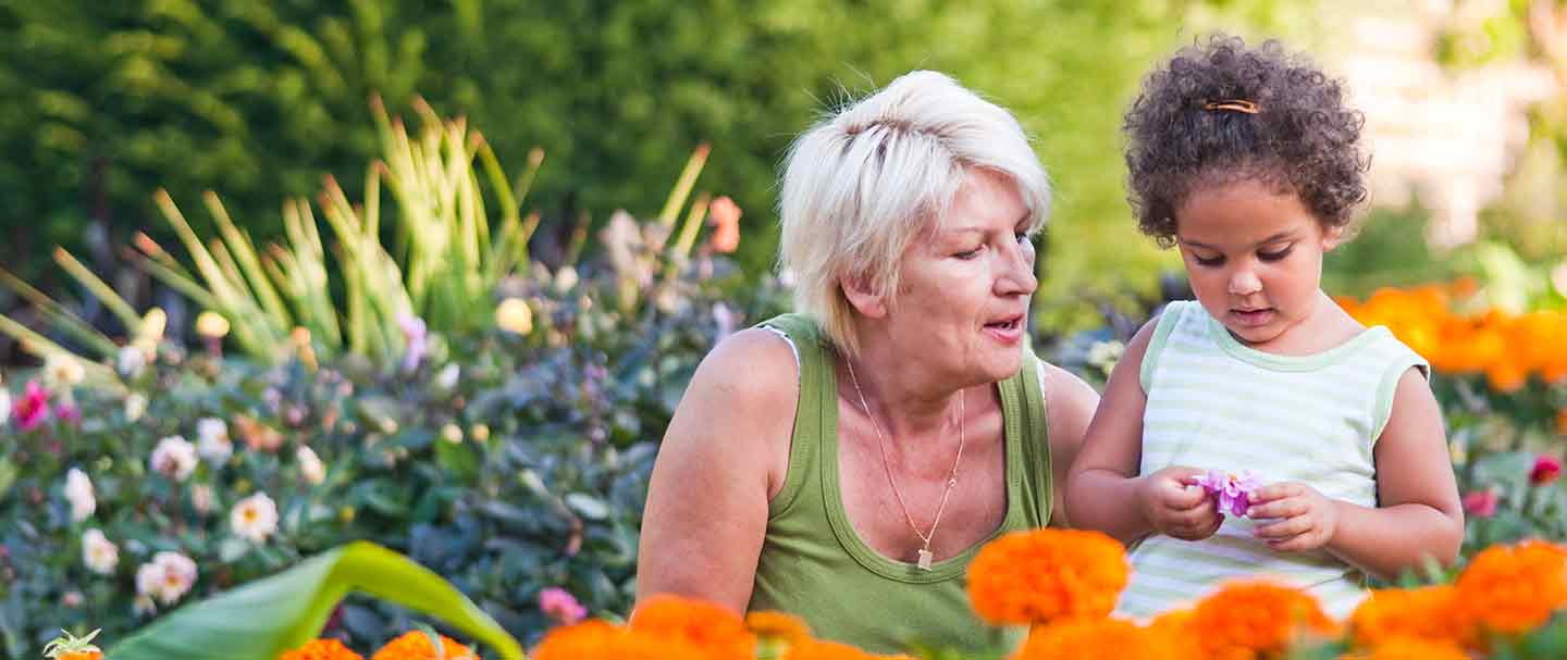 A woman and her granddaughter looking at flowers