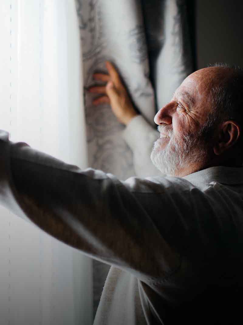 Man opening curtains
