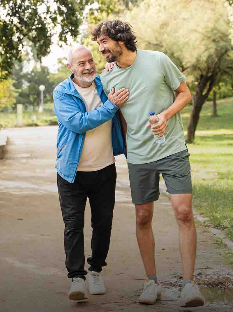 Father and son walking through a park