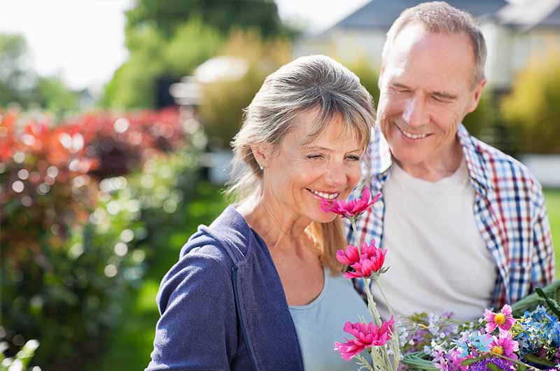 A woman smelling fresh flowers